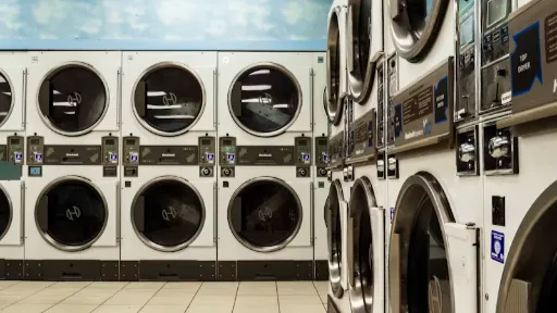 white washer and dryer laundry centers on white floor tiles