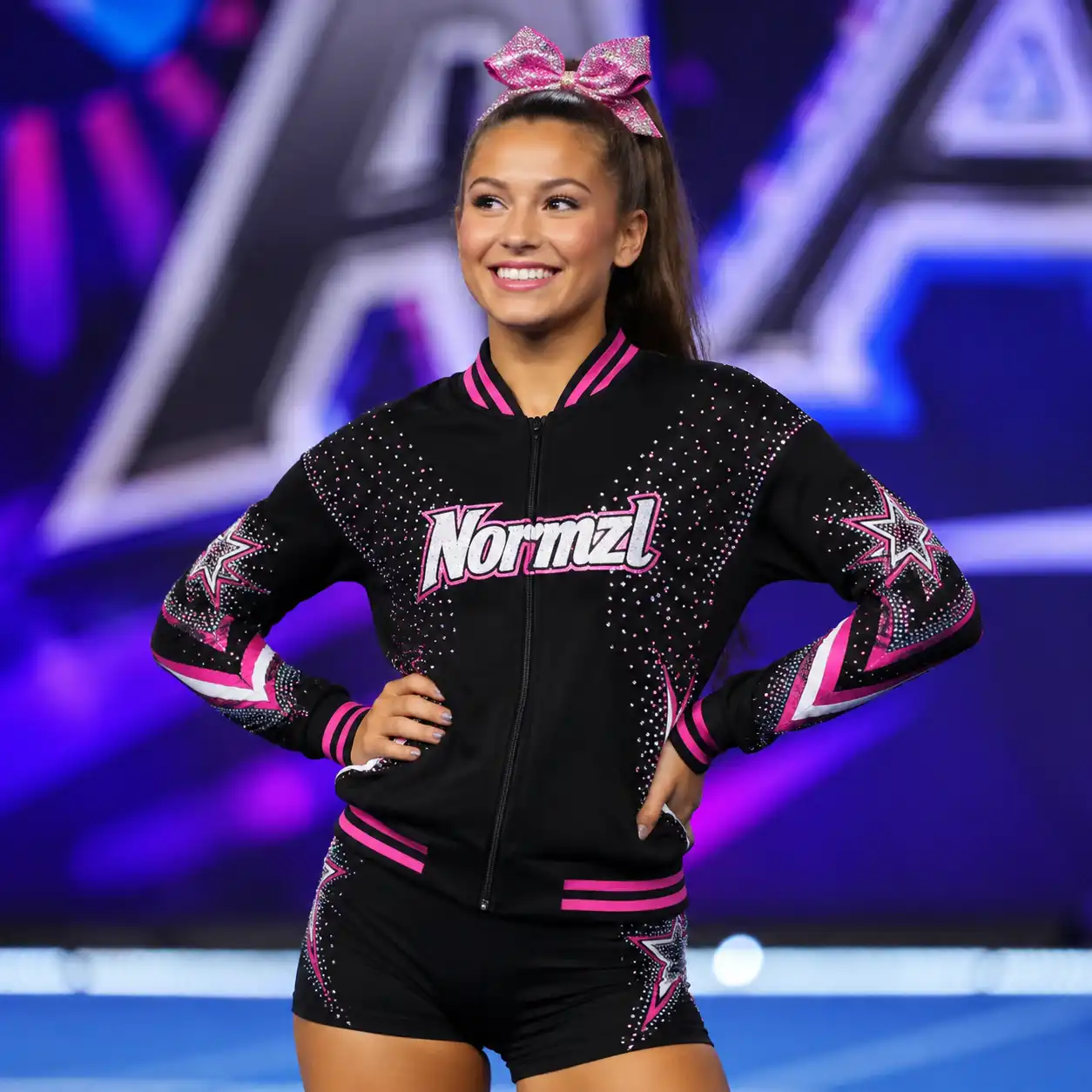 Cheerleader wearing a black and pink zip-up warmup jacket