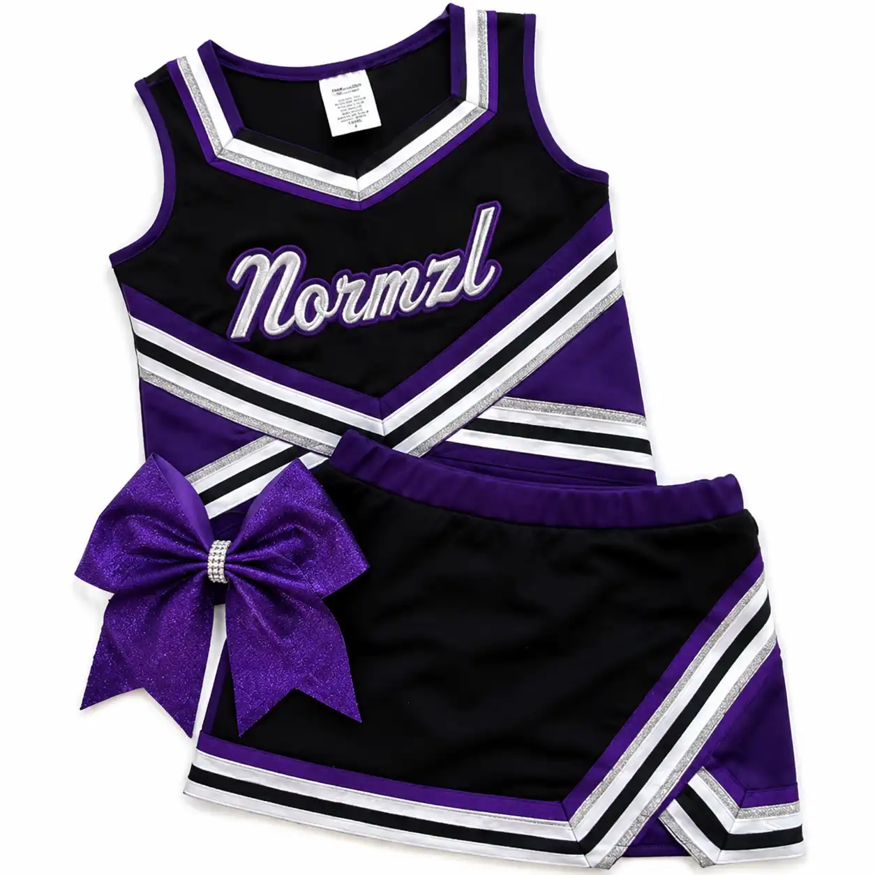 Flat lay of a black and purple cheer uniform shell top and skirt with a bow