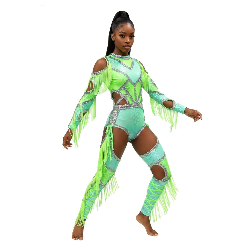 A majorette in a green performance uniform with fringe, crystals, and mesh cutouts